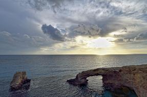 Beautiful Love Bridge in the sea, in sunlight in the clouds, in Agia Napa, Cyprus, Greece