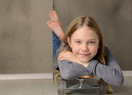 happy little girl with skateboard