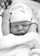 newborn baby in hat sleeping