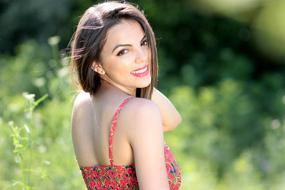 smiling girl in the garden close-up on a blurred background