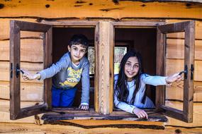 children in a wooden window