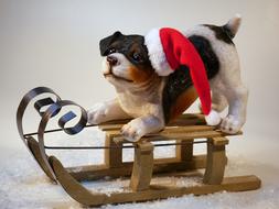 figurine of a puppy on a sled