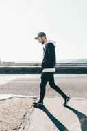 young Man Walking on pavement