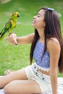 portrait of Girl and Parrot green grass