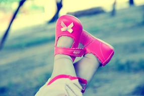 baby feet in pink shoes on a blurred background