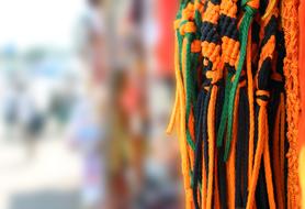colorful threads for sale in the market in a blurred background