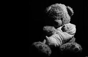 black and white photo of Teddy Bear and bear baby