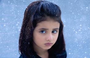 portrait of a little sad girl in winter