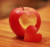 carved heart on red apple