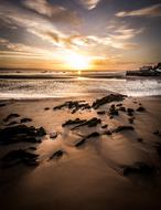 Beautiful sandy beach of Tenby at colorful sunrise in Wales