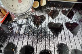 prints from Heart shape cookies on flour covered pan, Baking