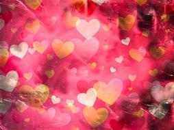 lot of golden hearts at red background