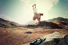 action photo of Man Jumping on mountain