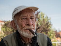 senior man smoking Cigar outdoor