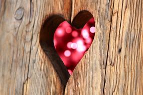 hole like a heart on a wooden door close-up