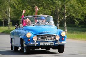 happy family in Old Skoda Auto on road