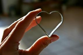 heart shaped cookie cutter in hand close up