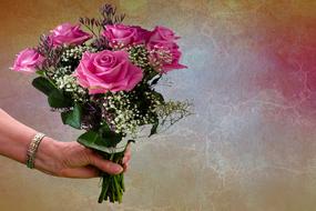 bouquet of pink roses in hand