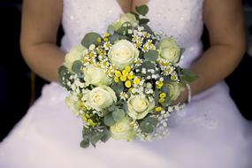 bride with a bouquet of white roses