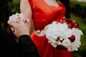 Couple and beautiful, white and red flowers of the girl in red dress