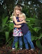 happy brother with sister in the garden