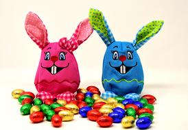 Colorful, smiling Easter Bunnies and colorful Easter eggs