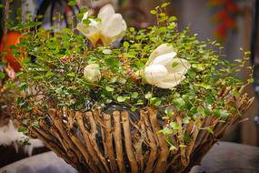 flower arrangement in a basket of branches