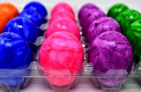 eggs of different colors in a box