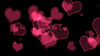 pink transparent hearts on black background