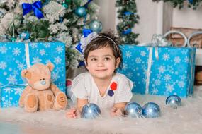 baby with a toy at a christmas photo shoot