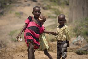 funny kenyan kids on the street in a blurry background