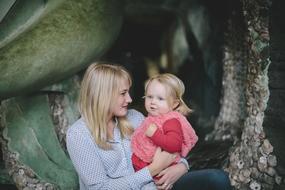 mom and daughter posing in the middle of nature