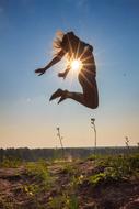 jumping human at sun glowing