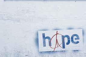 Colorful graffiti with the "hope" sign, at white wall background, clipart