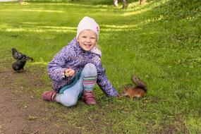 Kid girl and squirrel at park