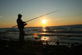 fishing on the ocean coast at dusk