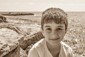 smiling boy on the seaside in monochrome