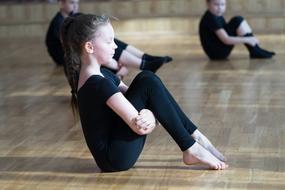 Kids, doing gymnastics exercise in the building, in light and shadows