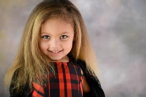 little beautiful girl posing on a blurred background