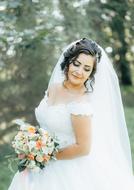 Bride with a bouquet on the street