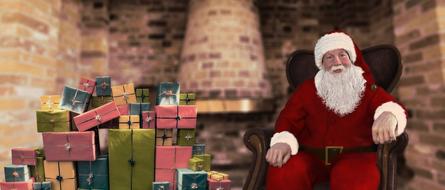 santa claus with a bunch of gifts on a blurred background