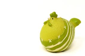 Beautiful and cute, green and white Easter chicken figure on the white surface