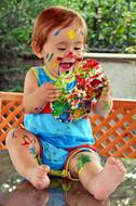 the child got dirty with colorful paints