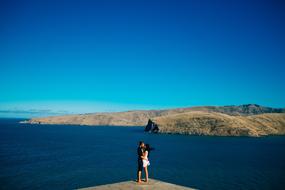 People kissing on coast