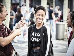 Laughing people together, on the street, outdoors