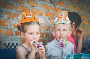 Kids sitting near the wall, on the celebration