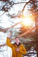 Man, showing hand, among the beautiful trees, in colorful sunlight