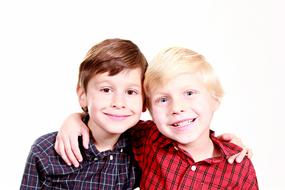 Portrait of the smiling brothers together, in light