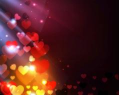 Beautiful and colorful hearts in light, at dark background, clipart