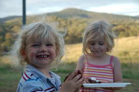 Lovely kids eating Chocolate Cake